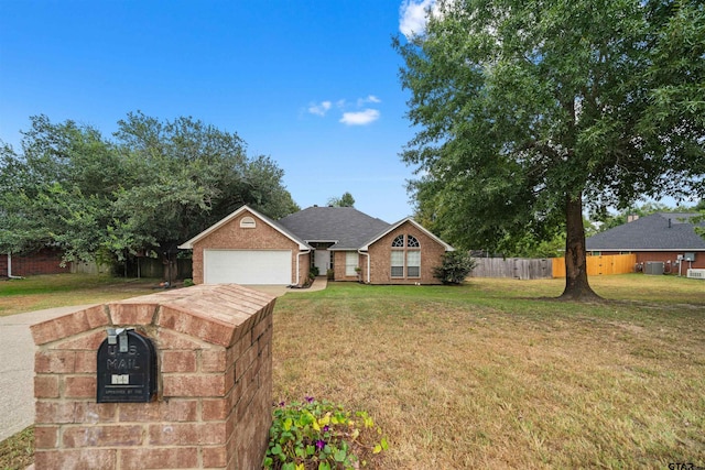 single story home with driveway, brick siding, a front lawn, and fence