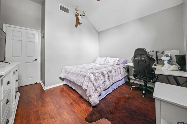 bedroom featuring visible vents, baseboards, lofted ceiling, and dark wood-style flooring