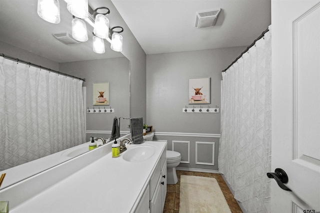 bathroom featuring tile patterned floors, visible vents, toilet, and vanity