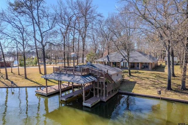 dock area with a water view and a lawn