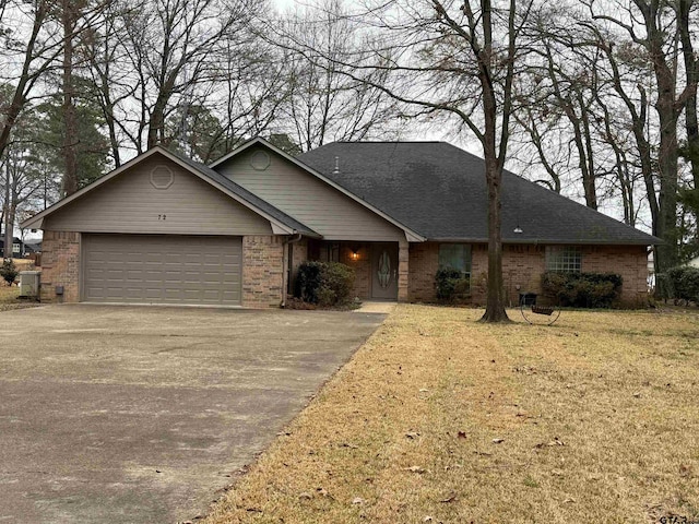 single story home featuring cooling unit, a garage, and a front lawn