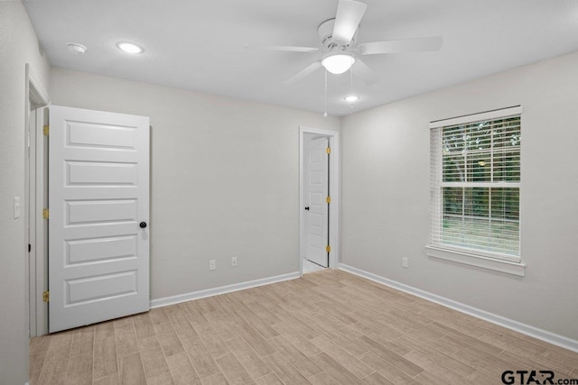 unfurnished room with ceiling fan and light hardwood / wood-style floors