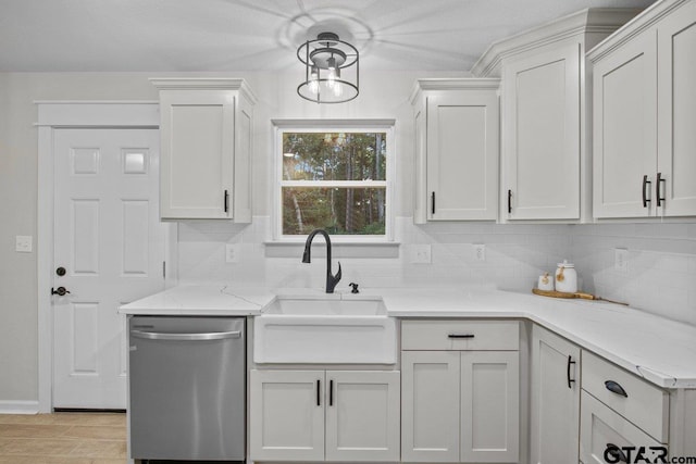 kitchen with stainless steel dishwasher, white cabinetry, pendant lighting, and decorative backsplash