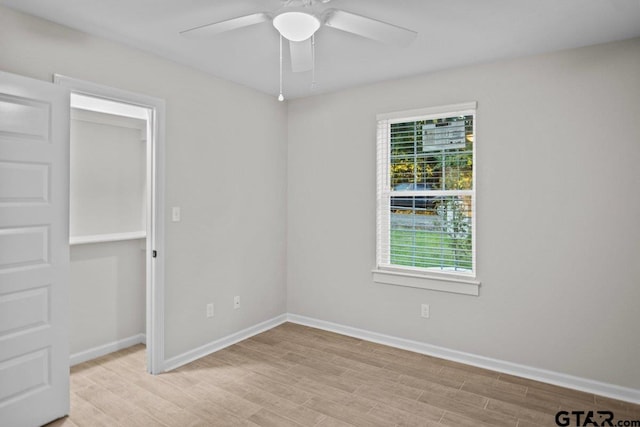 spare room with light hardwood / wood-style floors and ceiling fan