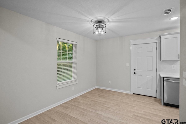 spare room with light hardwood / wood-style flooring