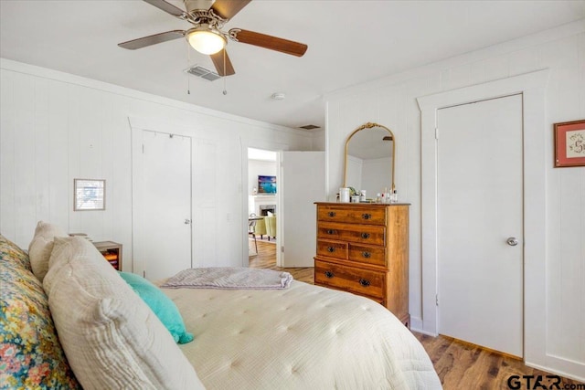bedroom with wood finished floors and a ceiling fan