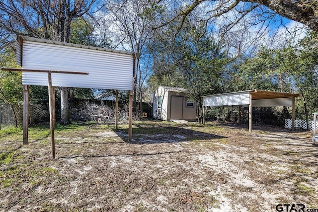 view of yard with a shed and a carport