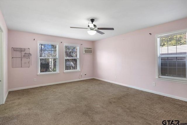 carpeted spare room featuring ceiling fan and a wall mounted air conditioner