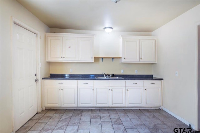 kitchen with sink and white cabinetry