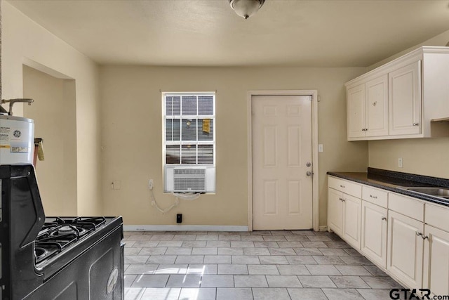 kitchen with white cabinetry and light tile patterned floors