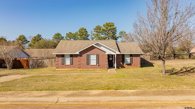 single story home with brick siding, fence, and a front yard