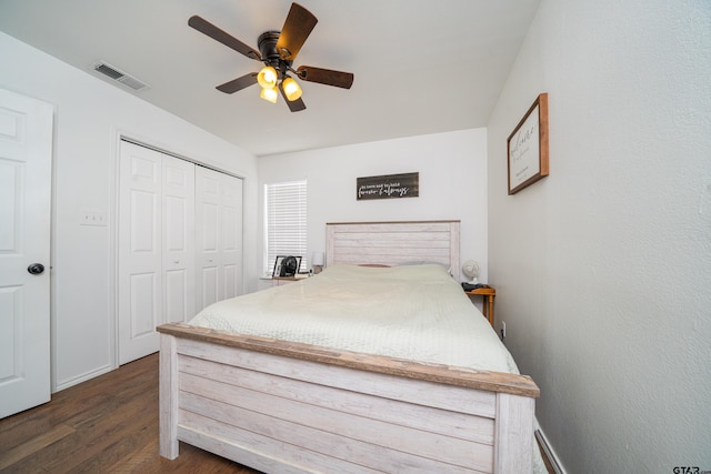 bedroom with a closet, visible vents, ceiling fan, wood finished floors, and baseboards