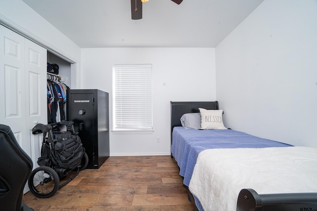 bedroom featuring a closet, wood finished floors, and a ceiling fan