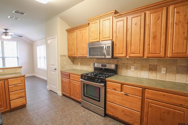 2559 Lazy Acres Ln, Tyler, TX 75707 - kitchen featuring stainless steel appliances, vaulted ceiling, baseboards, decorative backsplash, and ceiling fan