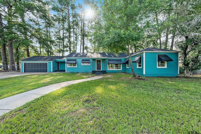 single story home with a garage and a front lawn