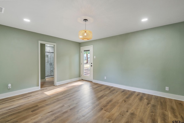 unfurnished room with hardwood / wood-style flooring