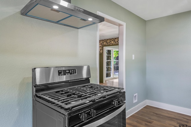 kitchen with stainless steel gas stove, dark wood-type flooring, and exhaust hood