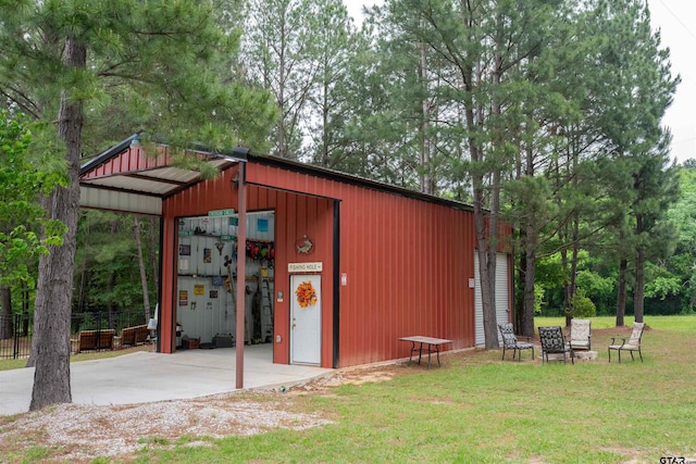 view of pole building featuring fence and a lawn