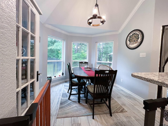 dining room featuring a wealth of natural light, light wood finished floors, an inviting chandelier, and lofted ceiling