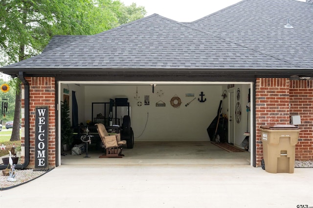 garage featuring concrete driveway