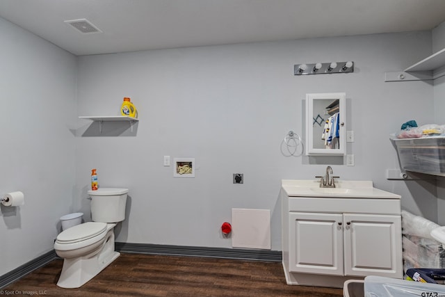 bathroom featuring hardwood / wood-style floors, vanity, and toilet