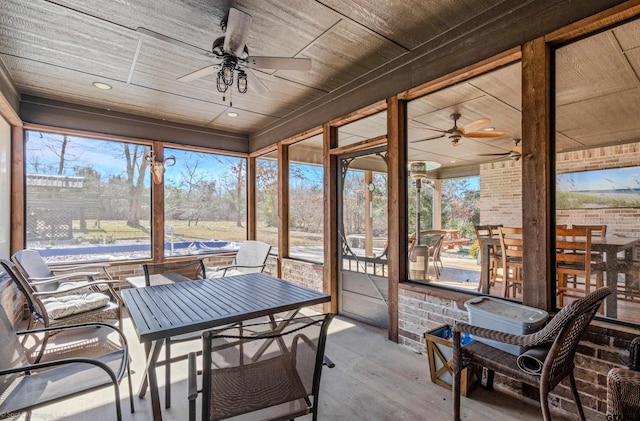 sunroom featuring a wealth of natural light, ceiling fan, and wood ceiling