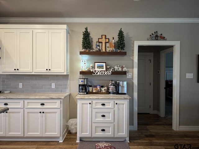 kitchen featuring white cabinets, tasteful backsplash, light stone countertops, and dark wood-type flooring