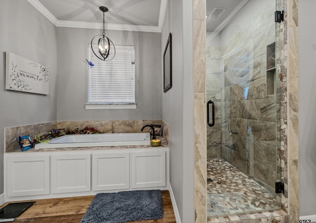 bathroom featuring hardwood / wood-style flooring, crown molding, shower with separate bathtub, and an inviting chandelier