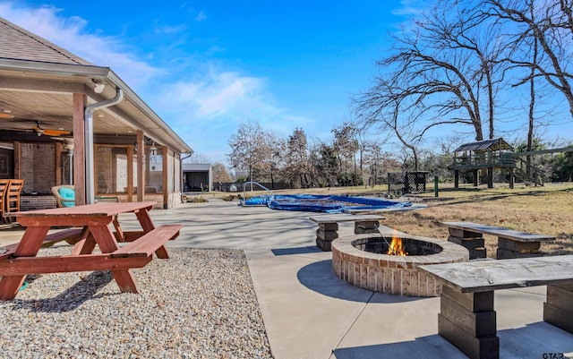 view of patio / terrace featuring ceiling fan and an outdoor fire pit