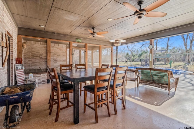 sunroom / solarium with ceiling fan and wood ceiling