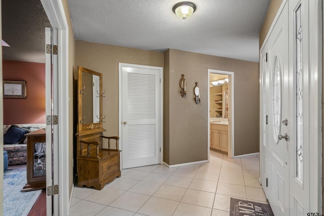 tiled foyer entrance with a textured ceiling