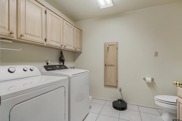 washroom with light tile patterned floors and washing machine and dryer