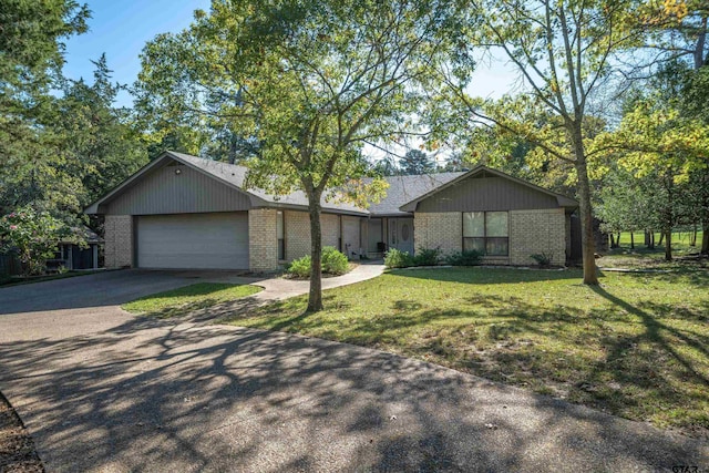 ranch-style home with a front yard and a garage