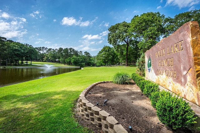 exterior space featuring a lawn and a water view