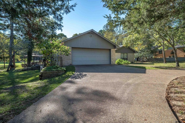 256 Ox Bow Cv, Holly Lake Ranch, TX 75765 - view of property exterior featuring asphalt driveway, brick siding, and a garage