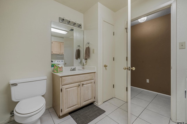 bathroom featuring tile patterned flooring, vanity, and toilet