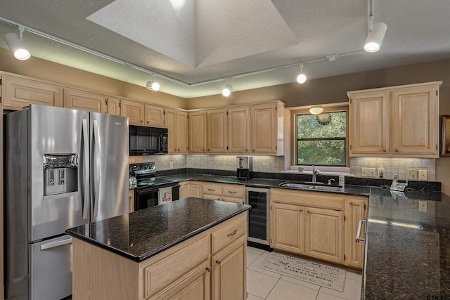 kitchen featuring light brown cabinets, black appliances, sink, a textured ceiling, and beverage cooler