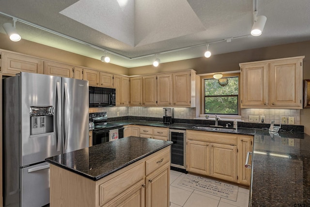 256 Ox Bow Cv, Holly Lake Ranch, TX 75765 - kitchen featuring black appliances, a sink, wine cooler, light brown cabinetry, and decorative backsplash