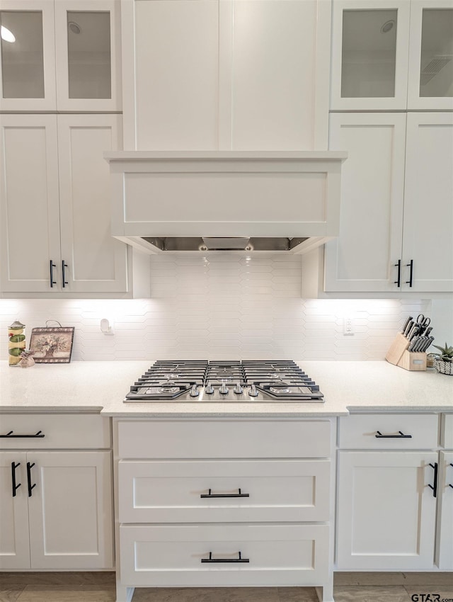 9070 Shallow Cv, Tyler, TX 75703 - kitchen featuring white cabinets, decorative backsplash, and light countertops
