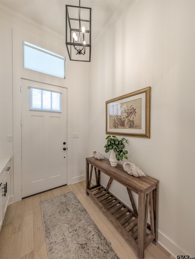 9070 Shallow Cv, Tyler, TX 75703 - entryway with a chandelier, crown molding, and light wood-style flooring
