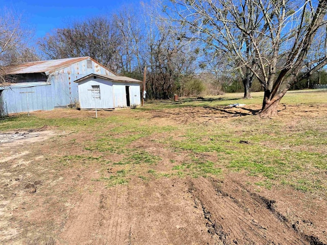 view of yard featuring an outbuilding and a pole building