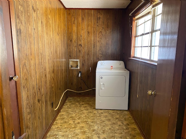 laundry area featuring laundry area, wooden walls, and washer / clothes dryer