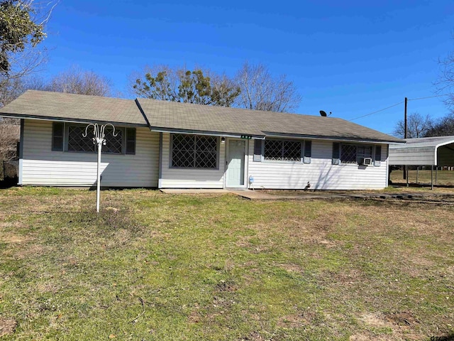 ranch-style home with a carport and a front lawn