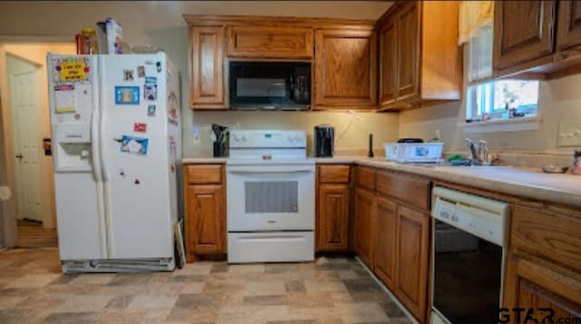 209 Kildare Rd, Linden, TX 75563 - kitchen featuring brown cabinetry, white appliances, and light countertops