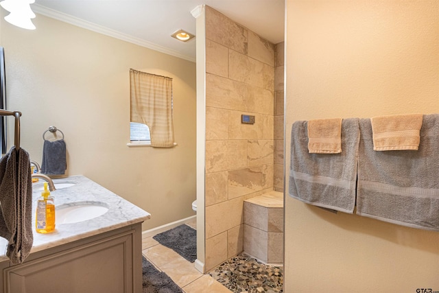 bathroom with tile patterned flooring, crown molding, vanity, and toilet