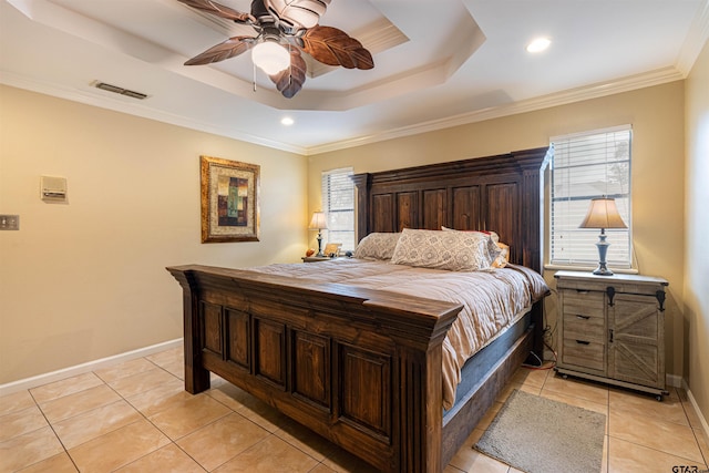 tiled bedroom featuring multiple windows, ornamental molding, ceiling fan, and a tray ceiling