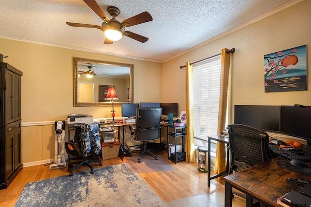 office with ceiling fan, crown molding, light hardwood / wood-style floors, and a textured ceiling