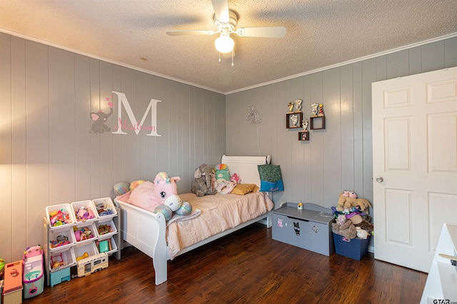 bedroom with crown molding, ceiling fan, dark hardwood / wood-style flooring, and a textured ceiling