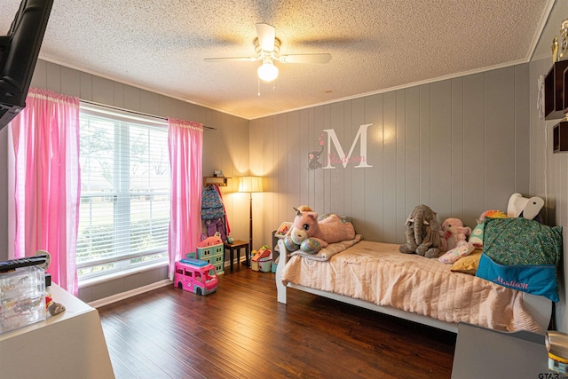 bedroom featuring crown molding, ceiling fan, dark hardwood / wood-style floors, and a textured ceiling