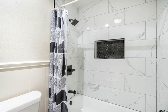 bathroom featuring toilet and shower / bath combo